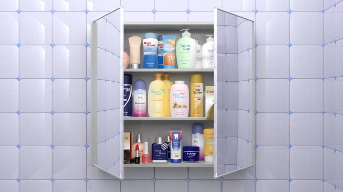 Open bathroom cabinet filled with various personal care products, including shampoos, creams, and deodorants, against tiled wall.