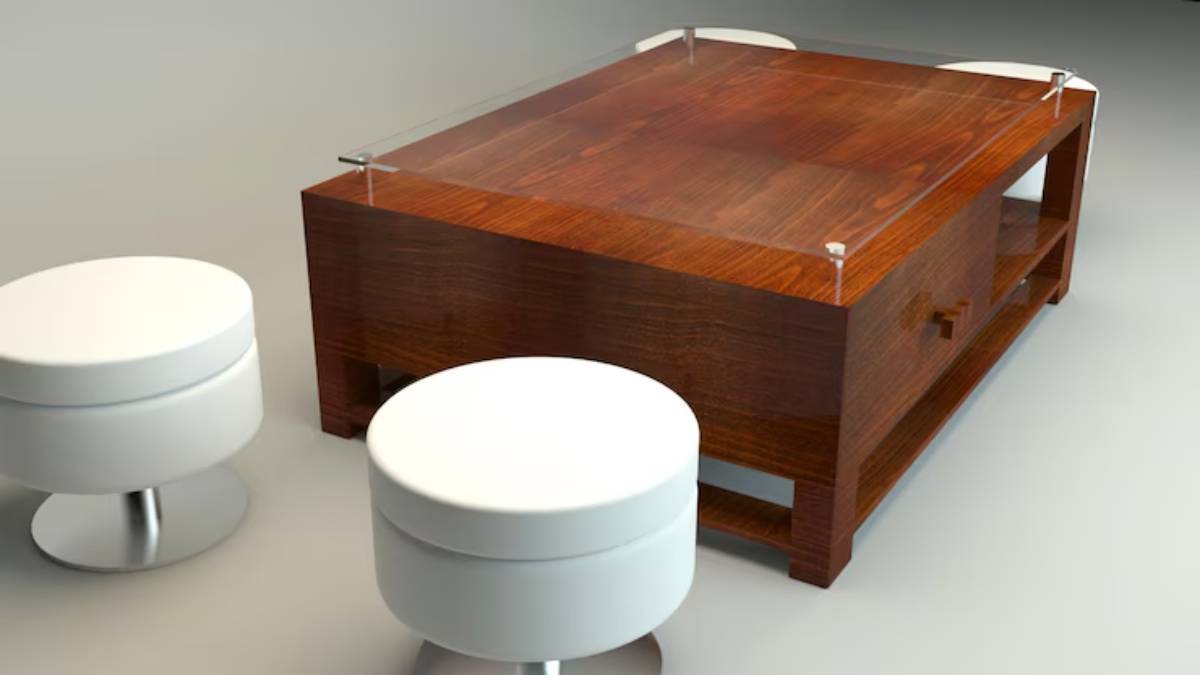 A wooden coffee table with a glass top, accompanied by two modern white stools on a light background.