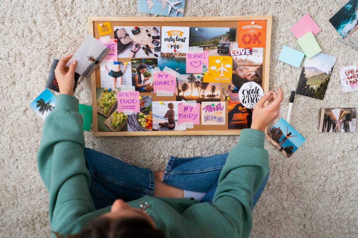 A person creates a vision board with photos and sticky notes, focusing on goals like travel, healthy living, and personal dreams.