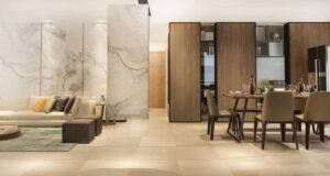 A modern living and dining area featuring a marble accent wall, elegant furniture, and a beautifully set dining table.